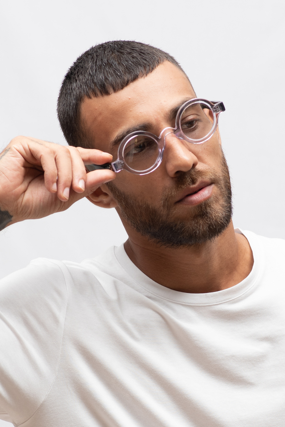 Clear acetate round spectacles worn by male model